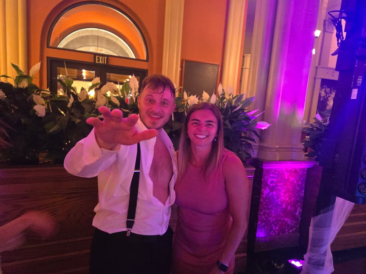 Candid celebration at a Narlie Productions event under pink stage lighting