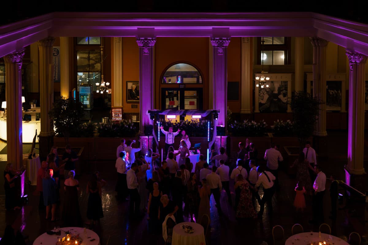 Wide view of a Narlie-produced dance floor with magenta column uplighting